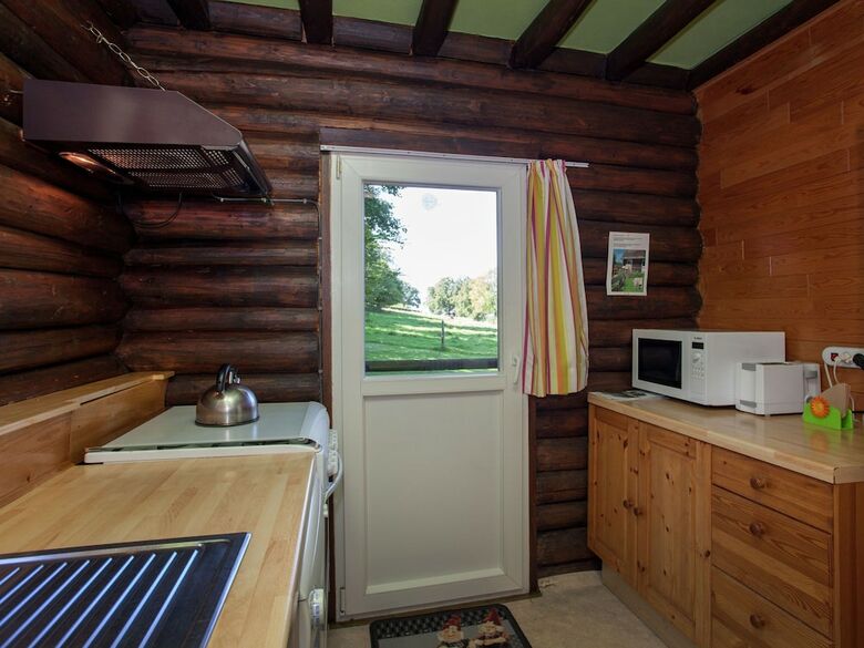 Open Wooden Chalet Built Against A Hill