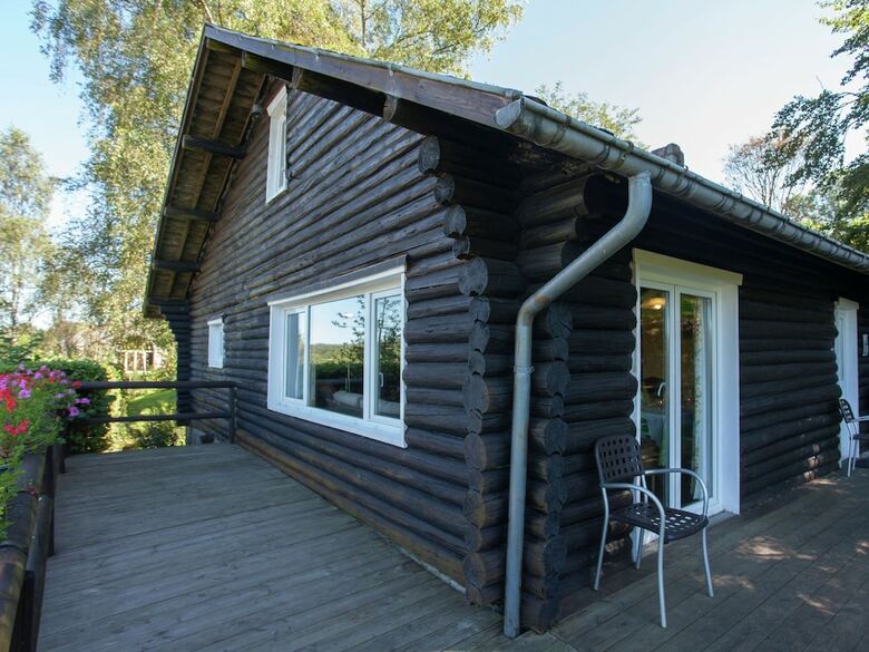 Open Wooden Chalet Built Against A Hill