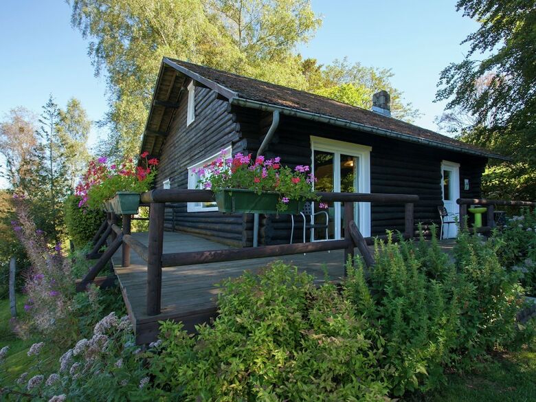 Open Wooden Chalet Built Against A Hill