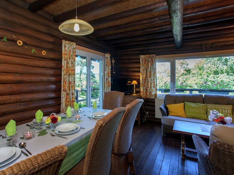 Open Wooden Chalet Built Against A Hill